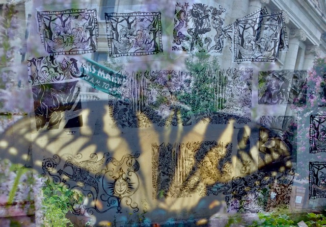 Darbury in front of wall with prints.